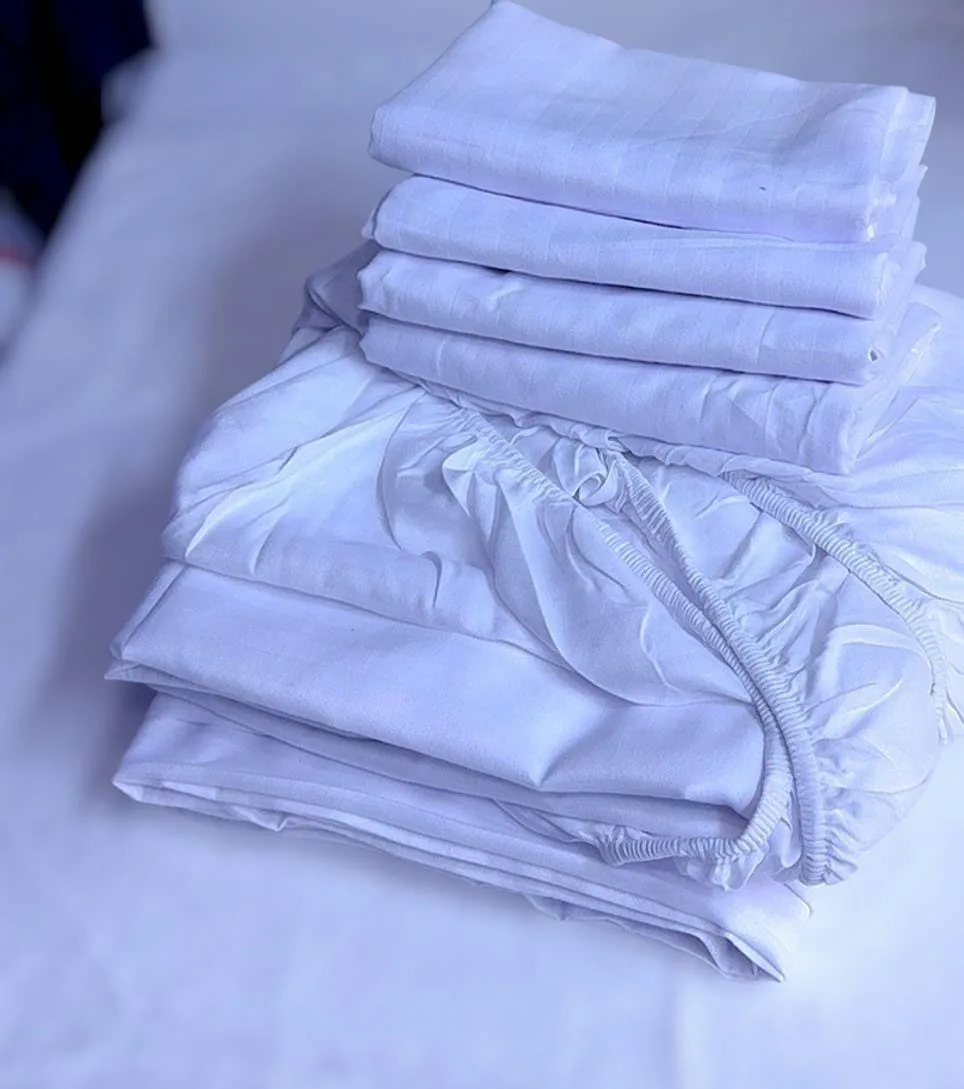 White fitted striped bedsheet set with flat sheet and pillowcases